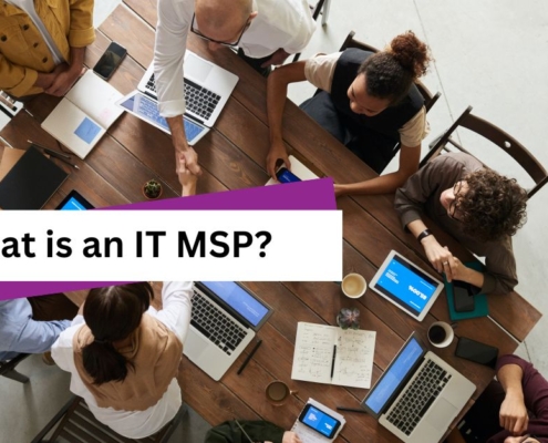 Group of employees at a large table with laptops