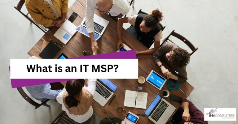 Group of employees at a large table with laptops