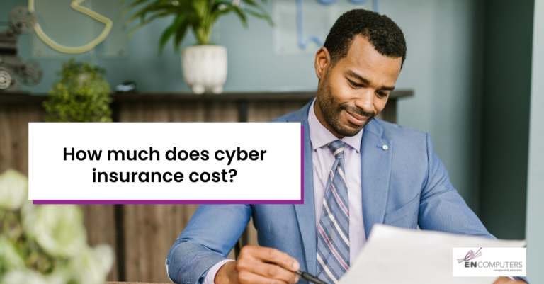 How much does cyber insurance cost? Background: Black man in blue suit holding document and pen