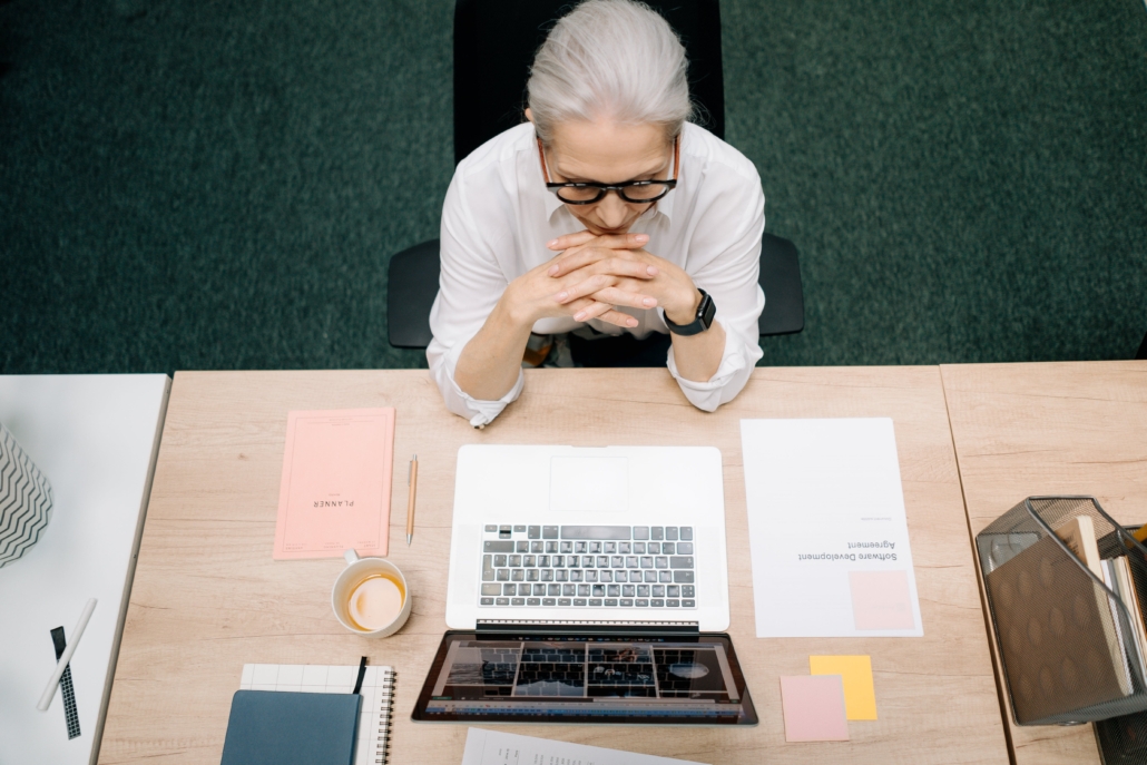 Professional woman at desk illustrating the question do iIneed a CMMC consultant