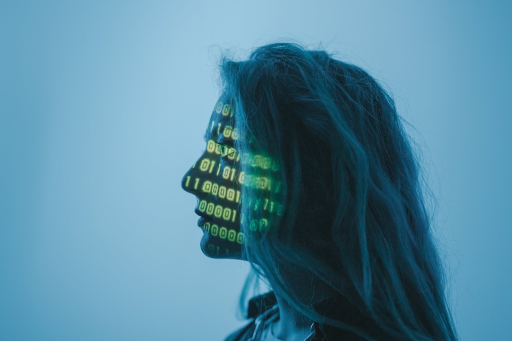 Woman with computer code projected on her face to represent cybersecurity firms for small business cybersecurity consulting in Arlington, Virginia