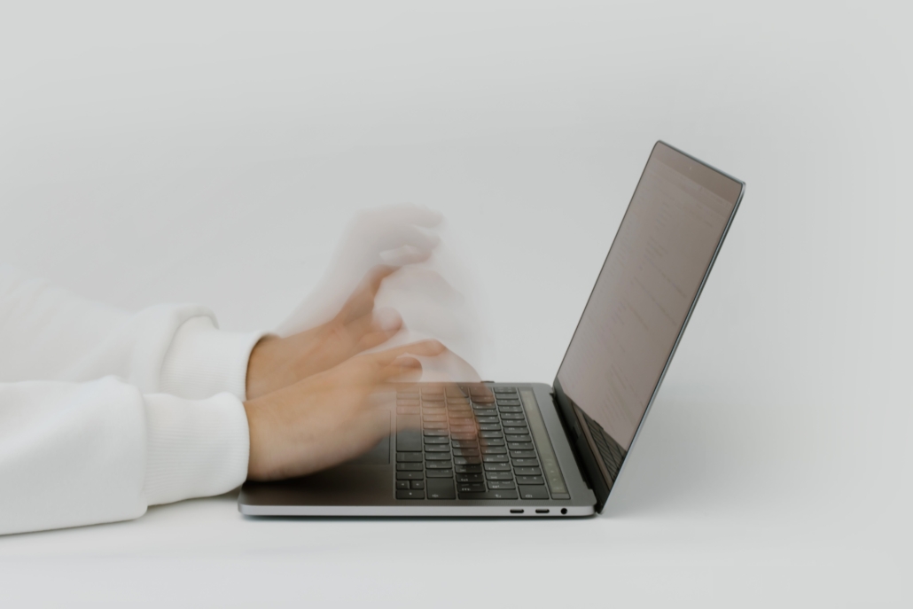 Hands rapidly typing on keyboard to represent cybersecurity concerns and need for Arlington small business cybersecurity consultants