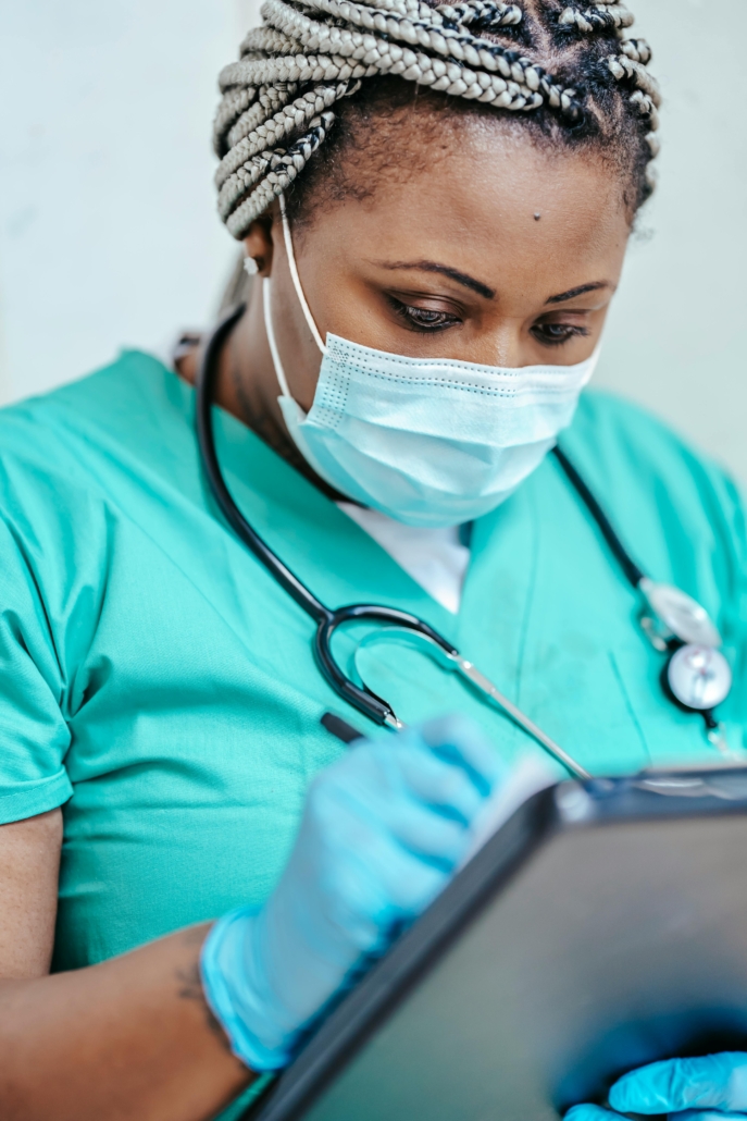 Medical professional using IT equipment illustrating IT support for health care