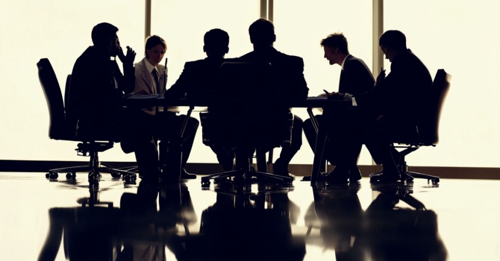 Silhouette of business people at a conference table