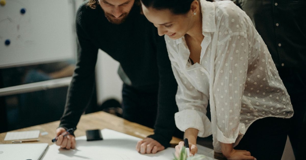 two people working together at a desk