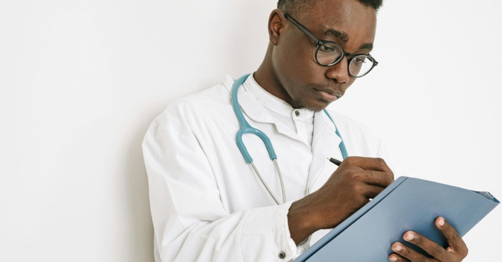 Doctor making notes on a medical chart