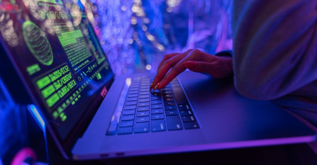 female hands typing on laptop