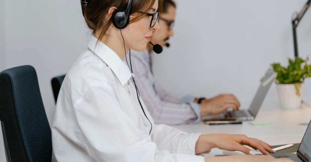 Two customer supprt people with headsets