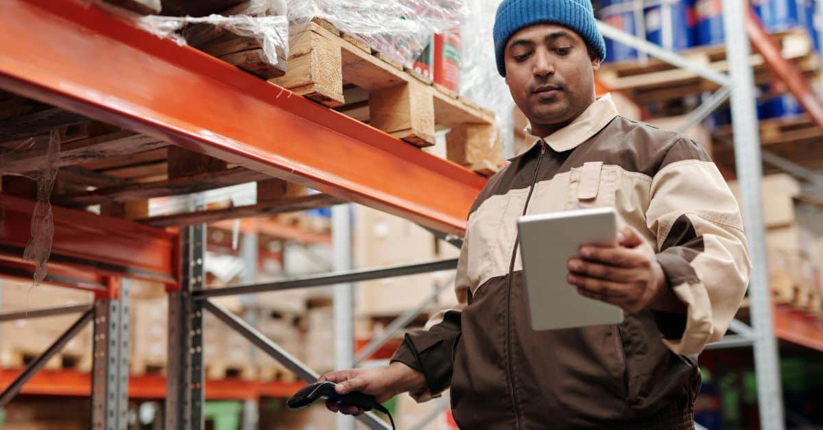 Business VoIP paging services worker doing inventory in a warehouse