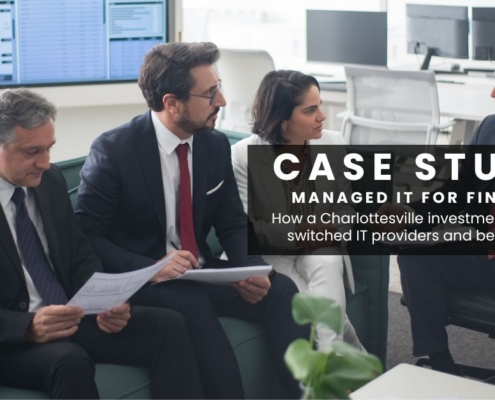 Four professionals - three men and a woman - in business attire sitting down reviewing documents. Text: Case study, managed IT for finance, how a Charlottesville investment advisor switched IT providers and benefitted